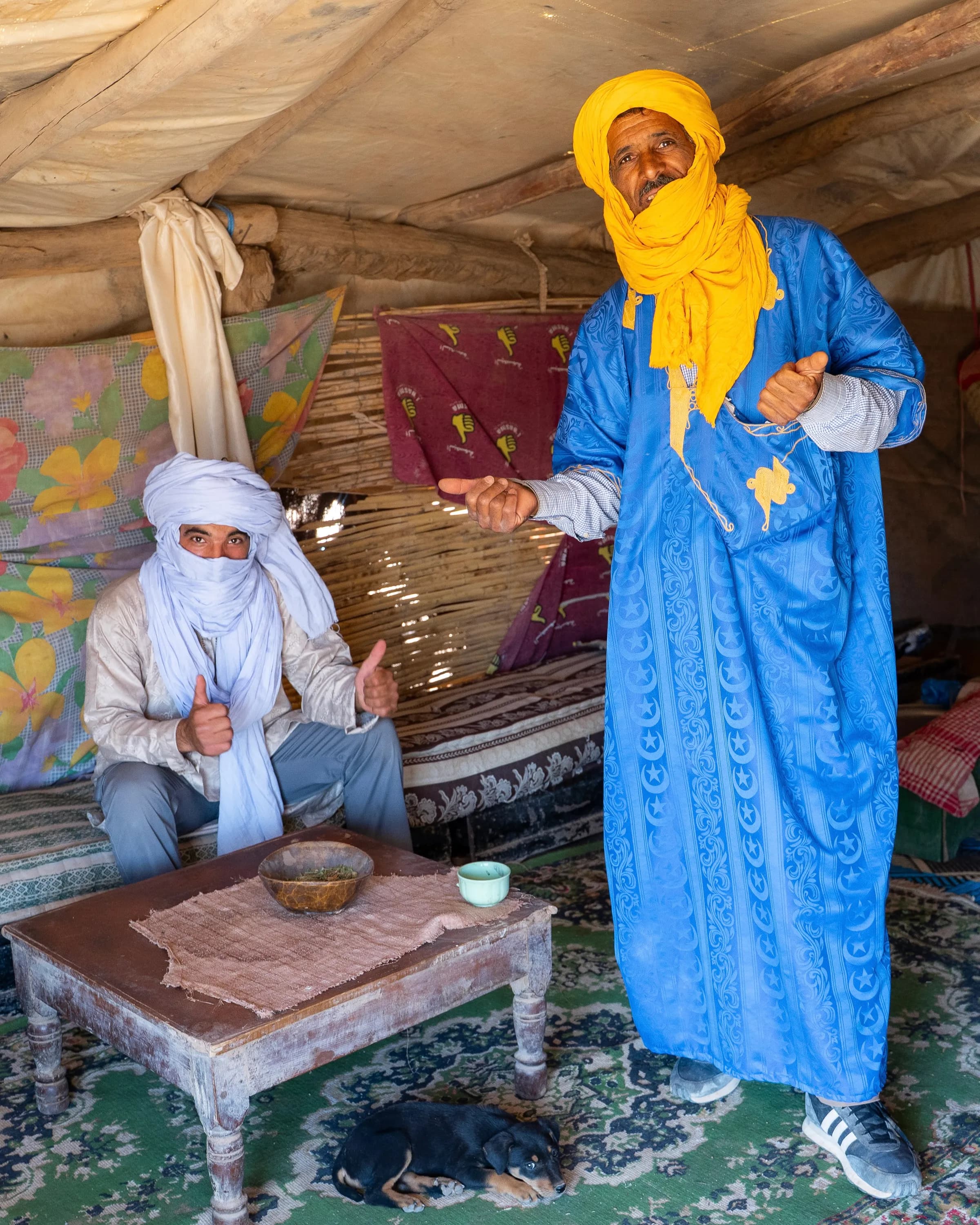 Hassan and Mohamed, father and son Touareg guides, sharing mint tea in their desert tent